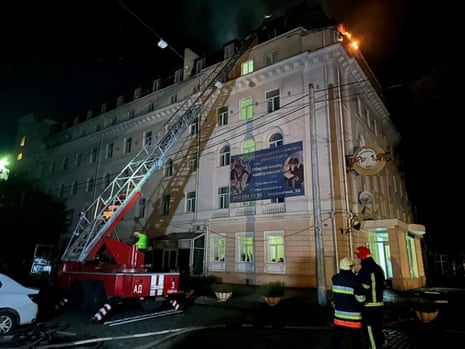 Firefighters work to put out a fire in a building in Odesa.