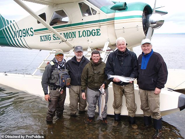 Leonard Leo, center, on the 2008 fishing trip with a guide and other guests. He is a key player in shepherding conservative judicial figures on to benches around the country
