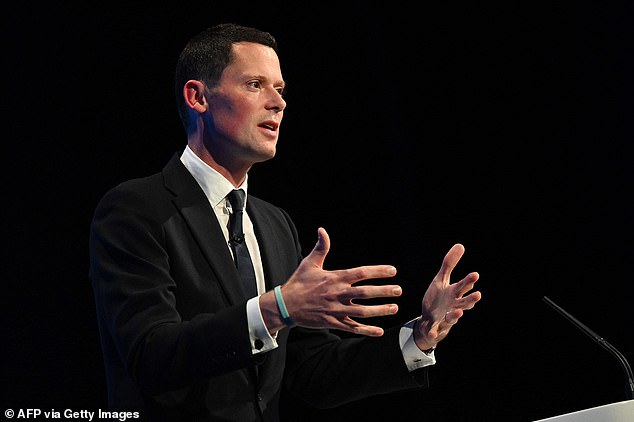 Britain's Justice Secretary Alex Chalk addresses delegates at the annual Conservative Party Conference in Manchester, northern England, on October 3, 2023